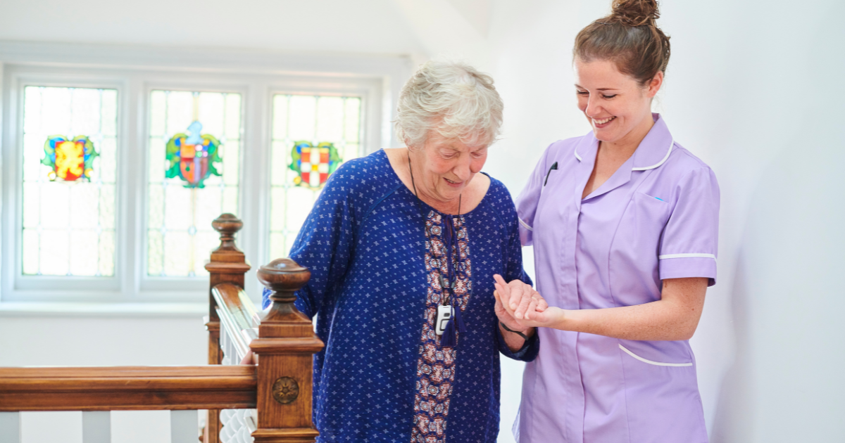 A senior adult receives care in the comfort of her own home from one of her caregivers who provide 24 hour home care.