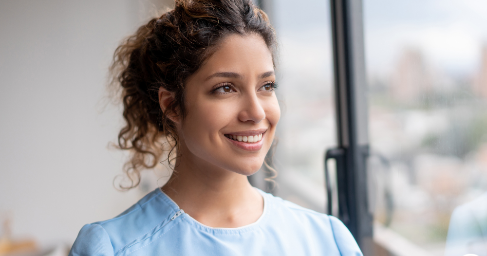 A woman hopefully and happily looks toward her future in the home care industry.