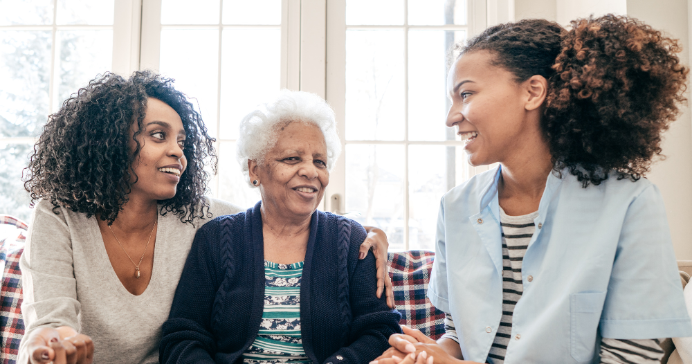 A professional explains senior care options to a woman and her aging mom.