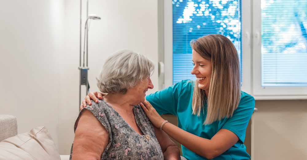 A home care provider compassionately tends to a senior client in their home.