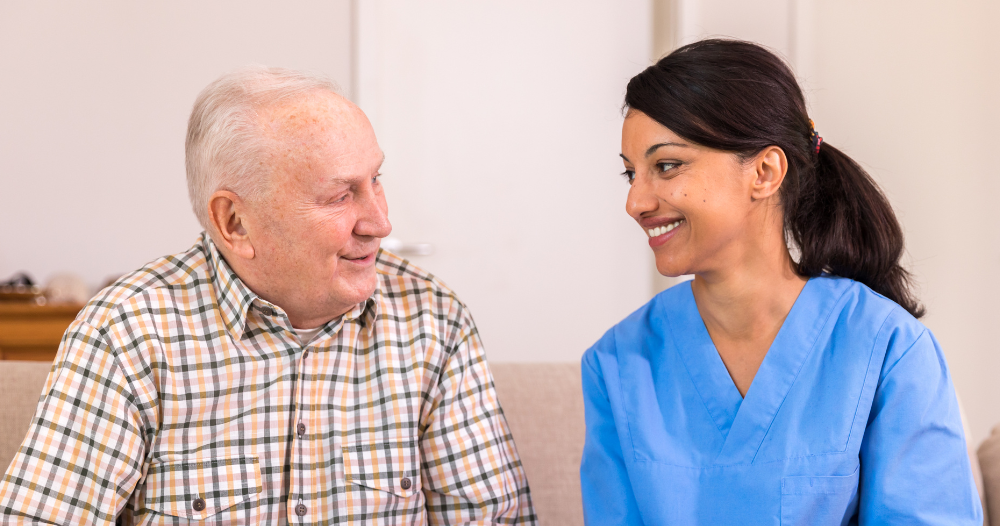 A professional caregiver enjoys her flexible career as she cares for and reads to an older client.