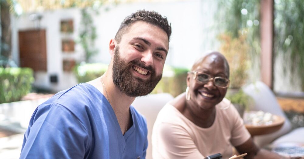 A happy caregiver and client represent the results of quality training and support for those in the caregiving field.