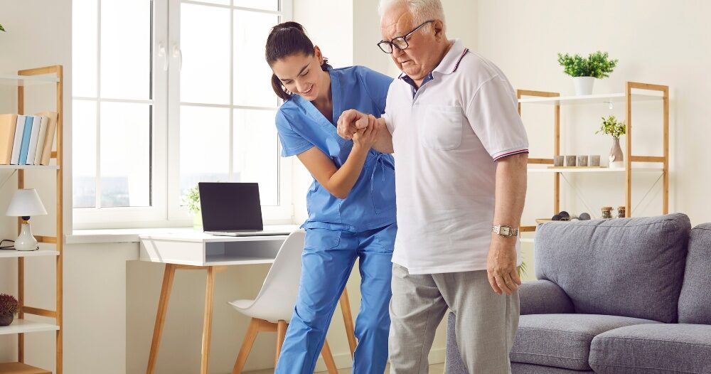 Seniors may need extra help after a fall, and elder care professionals, like this one helping a senior client, can make a massive difference.