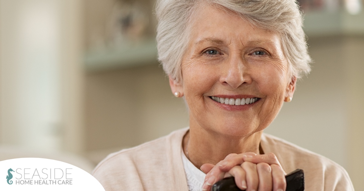 An older woman with healthy teeth smiles, representing good dental hygiene.