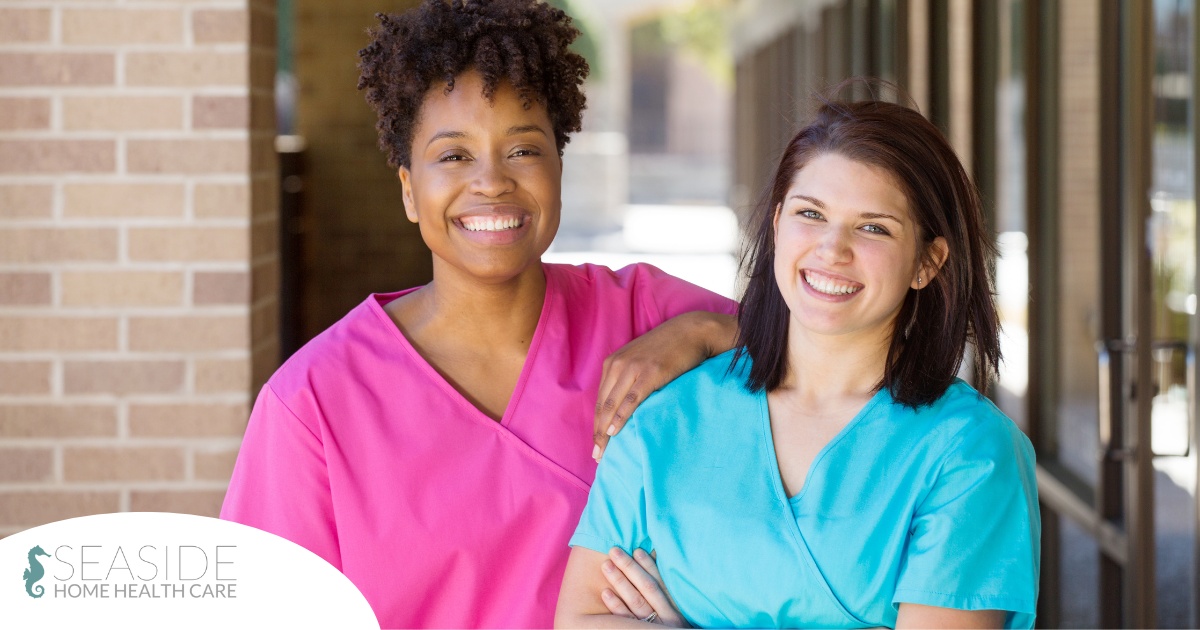 2 caregivers smile representing the good attitude that can allow home care professionals to collaborate.