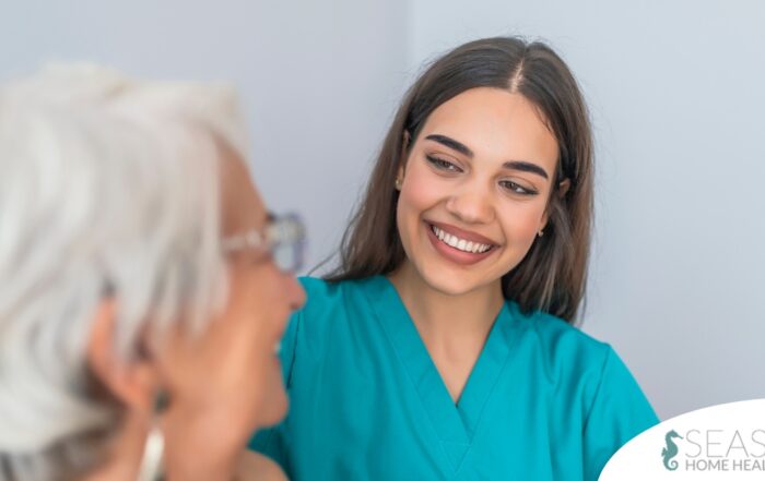 A caregiver smiles with an older client showing the results of successfully starting a new caregiving job.