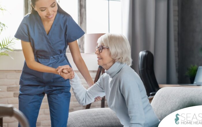 A caregiver demonstrates her caregiver skills by helping an older adult get up.