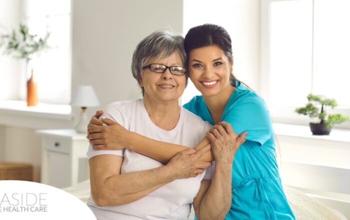 A caregiver hugs an older client, representing how a trustworthy caregiver cares for clients.