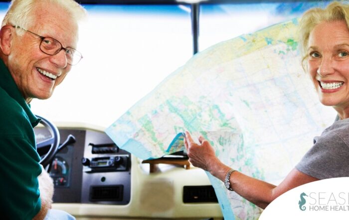 An older couple looks back smiling from the front of an RV, representing how day trips for seniors can help boost the mood of everyone.