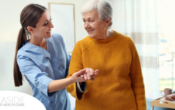 A caregiver helps a client get around, demonstrating one of the job duties of a caregiver.